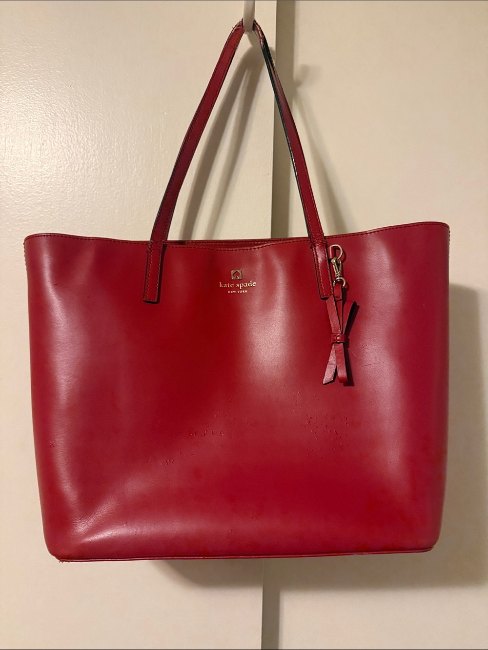 kate spade red leather tote with tassel charm